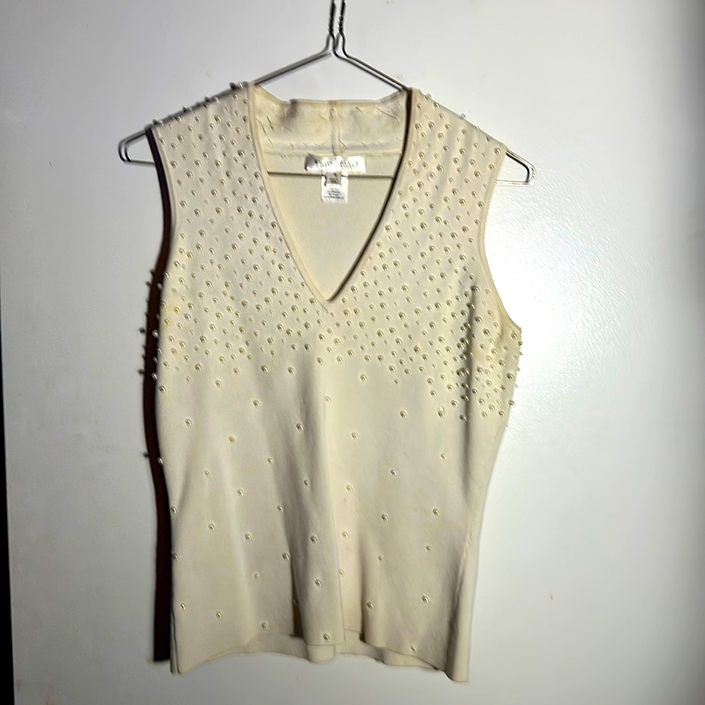 Light, sweater vest made of silk and spandex with white, fake pearls.